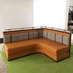 L-shape upholstered restaurant booth with houndstooth back and metal rail by Dejell