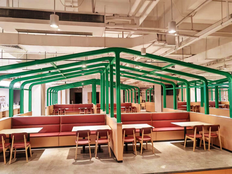 Custom canteen booth seating with green metal frame dividers by Dejell