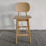 Scandinavian beech wood bar stool with curved back and solid wood legs by Dejell