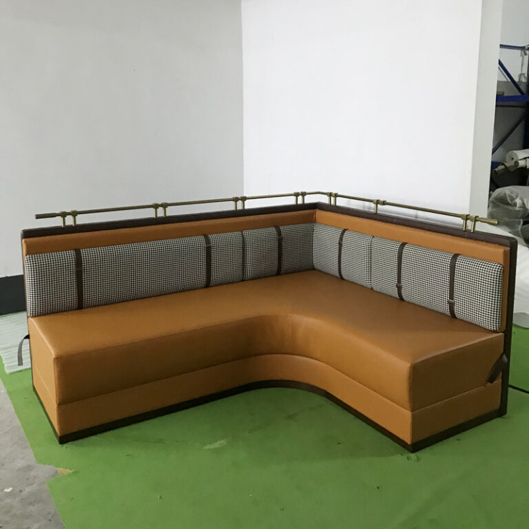 L-shape upholstered restaurant booth with houndstooth back and metal rail by Dejell