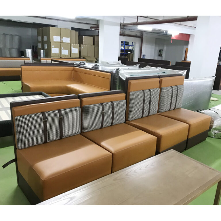 Modular restaurant booth seating with houndstooth back and leather strap detail by Dejell