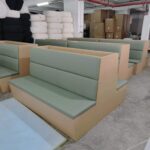 Restaurant booth seating sage green upholstery in Dejell factory production line