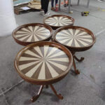 Multiple ash wood round side tables in production at Dejell factory