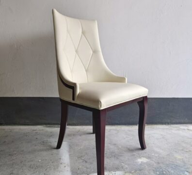 Side view of diamond tufted restaurant chair with curved ash wood legs