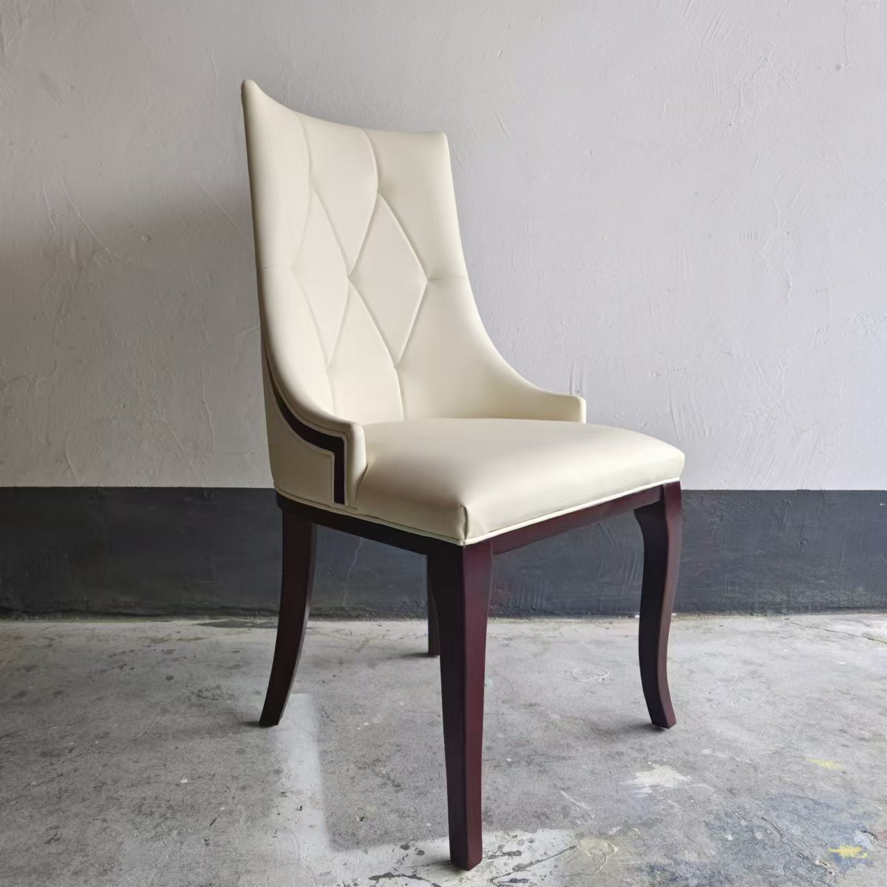 Side view of diamond tufted restaurant chair with curved ash wood legs