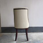Back view of diamond tufted dining chair showing ash wood frame and upholstery