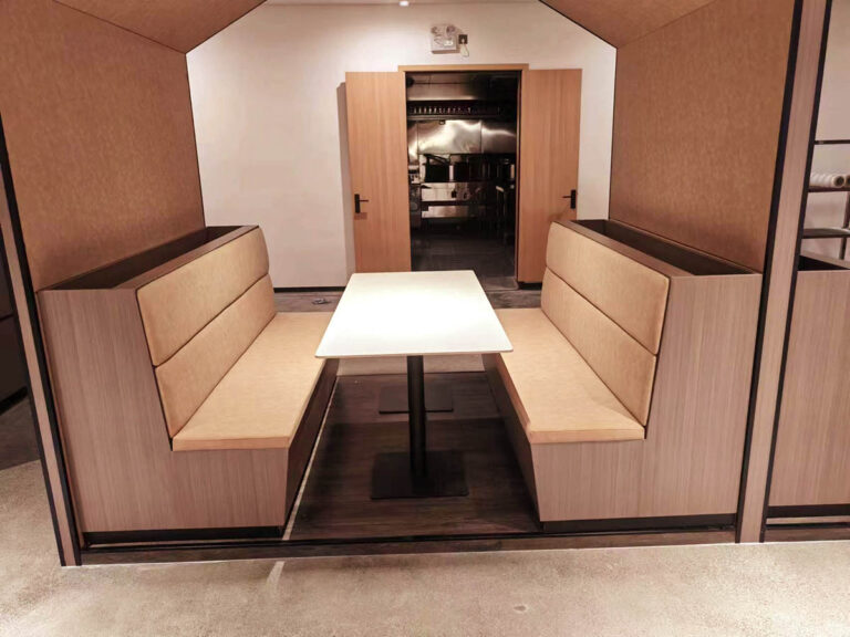 Private booth dining area with beige upholstered seating by Dejell
