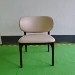 Dejell cream white upholstered dining chair with asymmetric curved backrest and solid walnut wood frame - front view