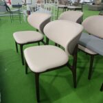 Dejell cream white curved backrest dining chairs in production group view