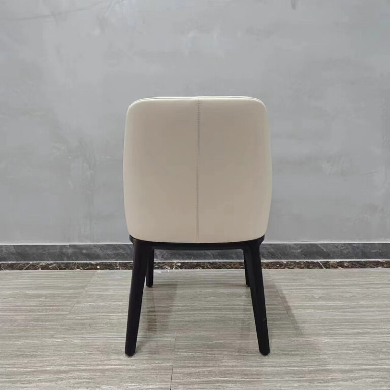 Back view of upholstered dining chair with curved high backrest and solid wood frame by Dejell