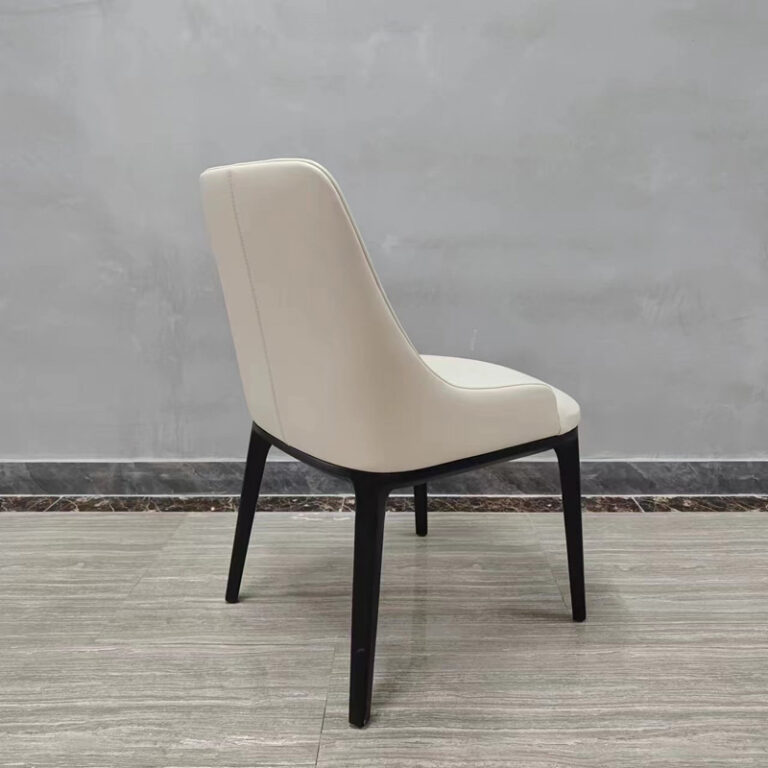 Rear angled view of cream white commercial dining chair showing backrest detail and black wood frame by Dejell
