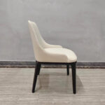 Side view of cream white faux leather dining chair with contoured back profile by Dejell