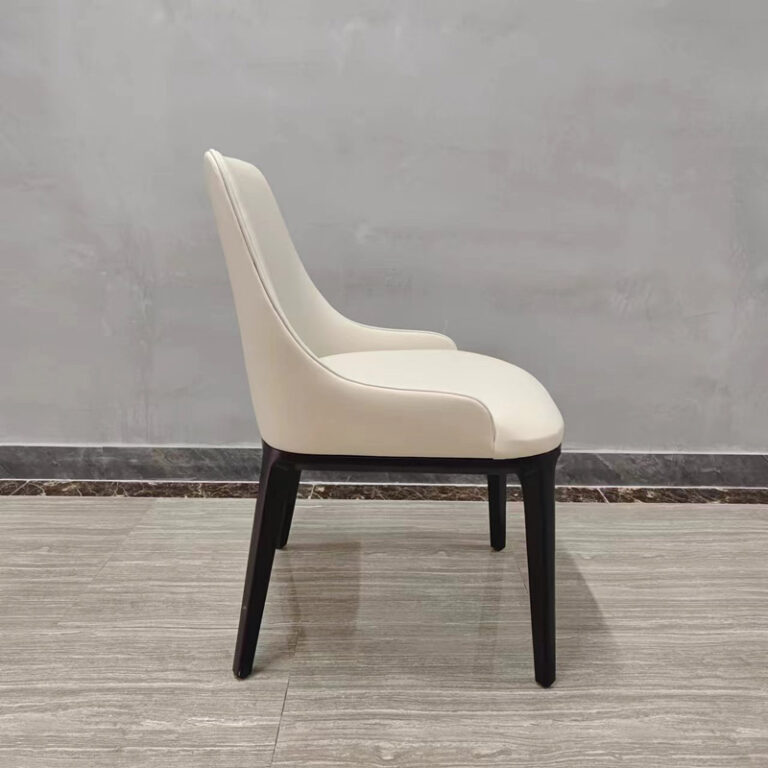 Side view of cream white faux leather dining chair with contoured back profile by Dejell