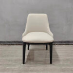 Cream white upholstered dining chair with curved wraparound backrest and solid wood frame by Dejell