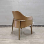 Dejell GD-W106 dining chair back view showing curved leatherette backrest and horizontal wooden armrest bar