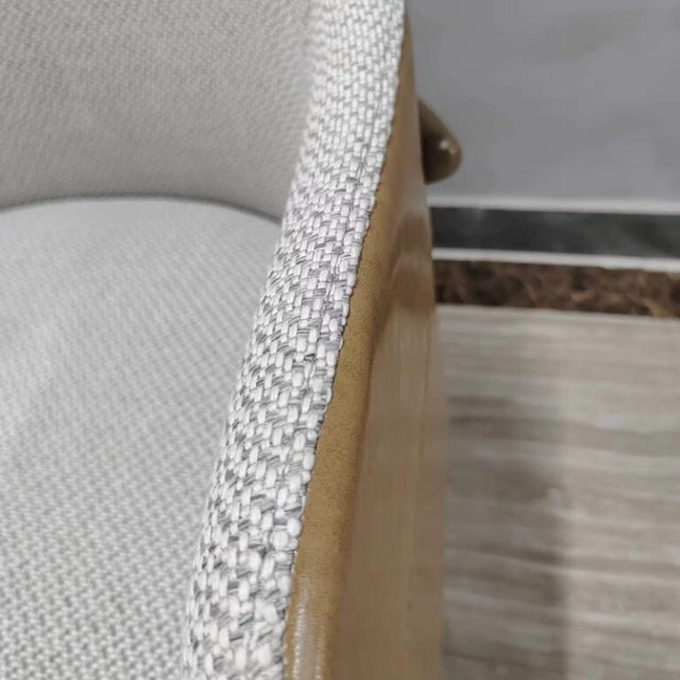 Dejell GD-W106 dining chair leather-to-fabric transition edge with contrast stitching detail