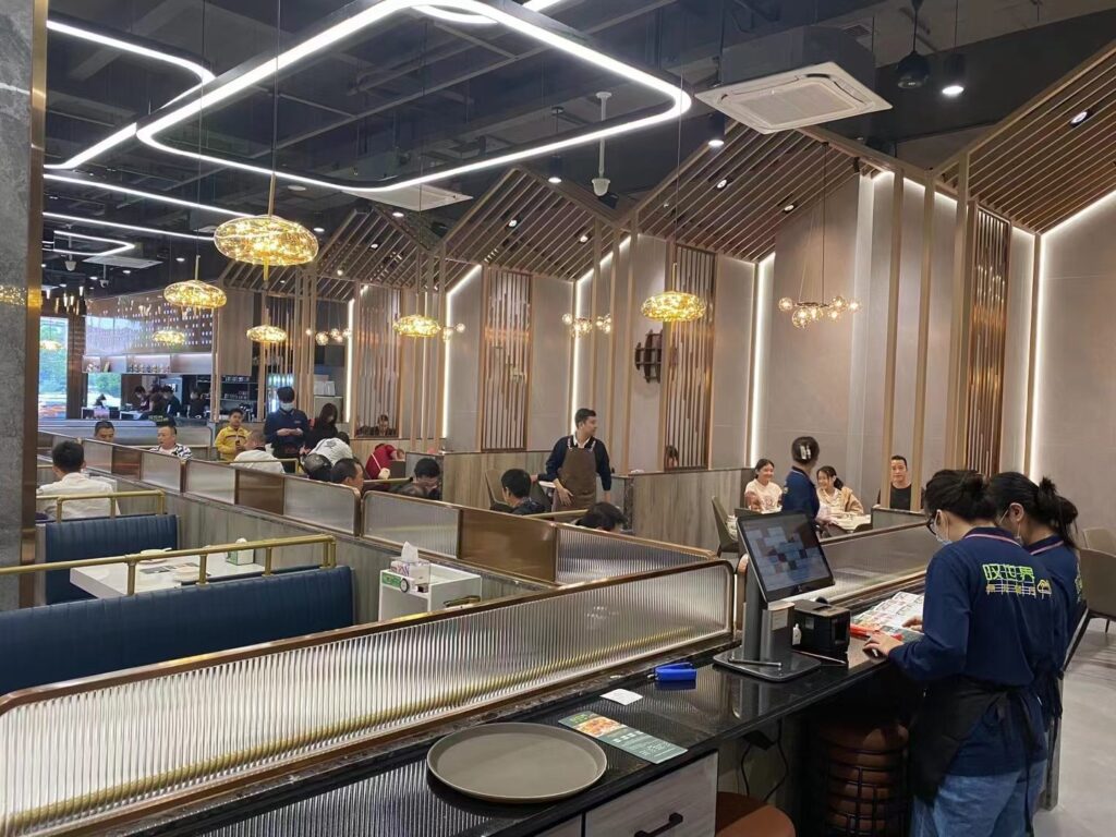 White stone-look dining tables at Tan Shijie restaurant