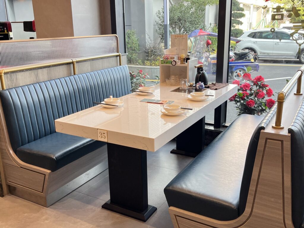 Dining chairs paired with booth seating at Tan Shijie